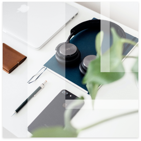 Leon logo overlay on neatly arranged desk with computer, headphones and smart phone.