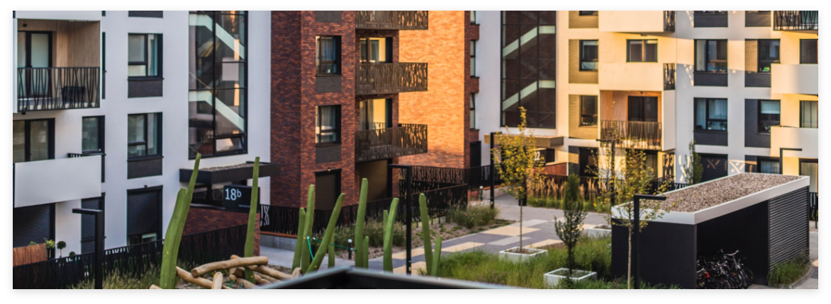 Apartment courtyard with lush landscaping and balconies.